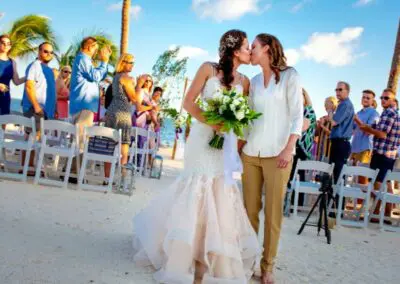 A romantic kiss between a bride and groom on a beach in Chicago, IL
