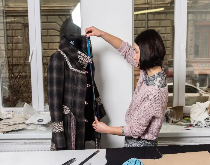 bespoke-women-vests A tailor at Richard Bennett Custom Tailors is measuring a stylish women's overcoat in Chicago, IL